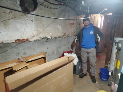 Decorative: Owner giving thumbs up in a basement with junk