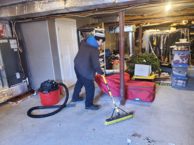 Decorative: The owner sweeping a garage floor